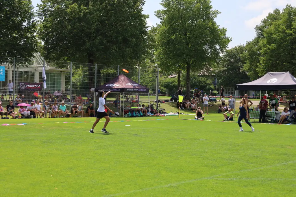 Bildergalerie vom Frisbee Festival M&uuml;nchen an der Sportschule Oberhaching mit Spielszenen auf dem Sportplatz und in der Halle, Turnierst&auml;nden, Zuschauerinnen und Zuschauern sowie verschiedenen Frisbee-Disziplinen wie Disc Golf, Ultimate Frisbee und Freestyle.
